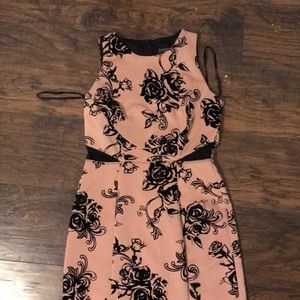 Pink dress with black flower pattern.